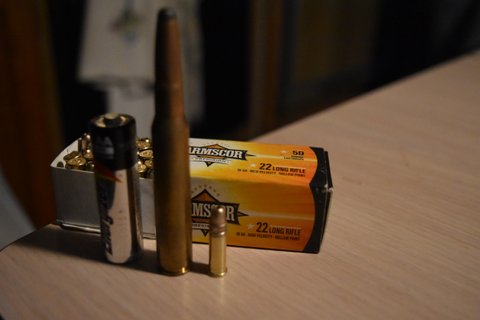 .22 LR compared to AA battery and a .30-06